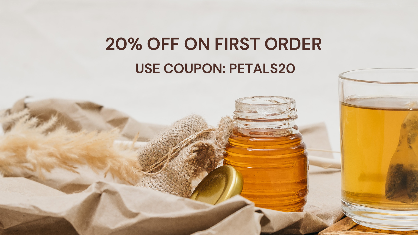 20% off Twinpetals tea banner with PETALS20 coupon code, featuring honey jar and herbal tea