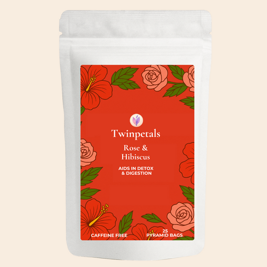 Front packaging of Twinpetals Rose & Hibiscus Tea – a caffeine-free floral detox blend that aids digestion, featuring hand-drawn rose and hibiscus flowers on a bright red background